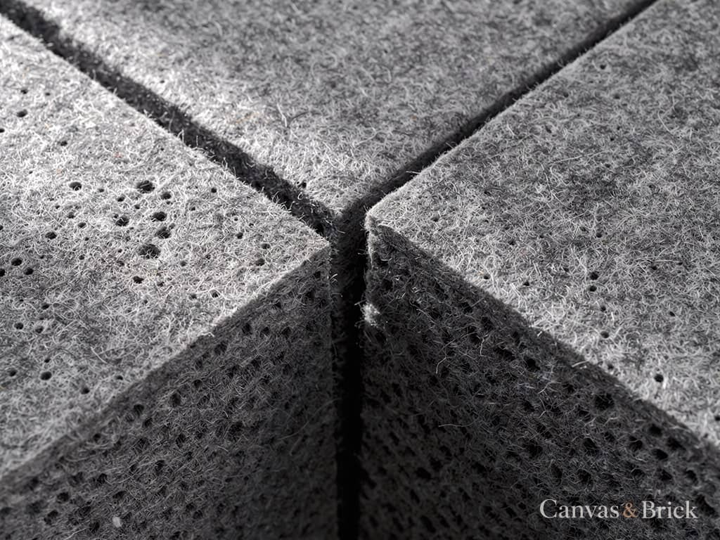 Fabric-wrapped acoustic panel in charcoal PET felt with a bevelled edge
