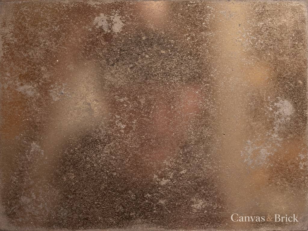 Antique bronze-tinted mirror with softly mottled silvering giving a warm smoky reflection