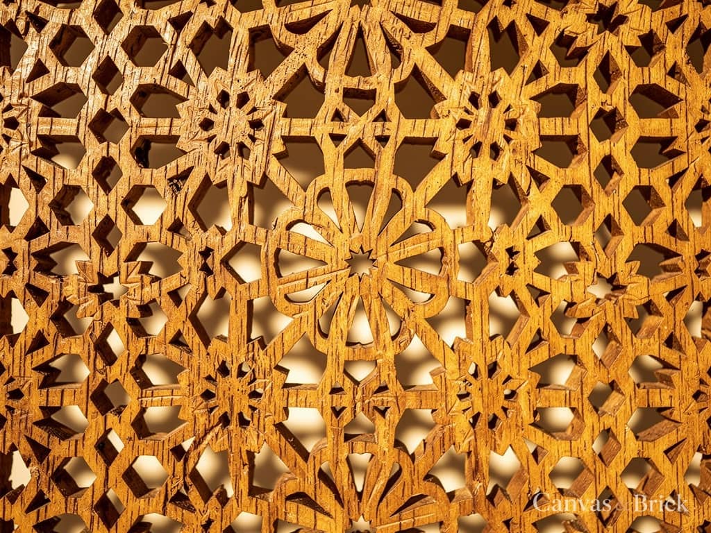 Hand-carved teak jaali screen, an intricate pierced geometric pattern with light passing through