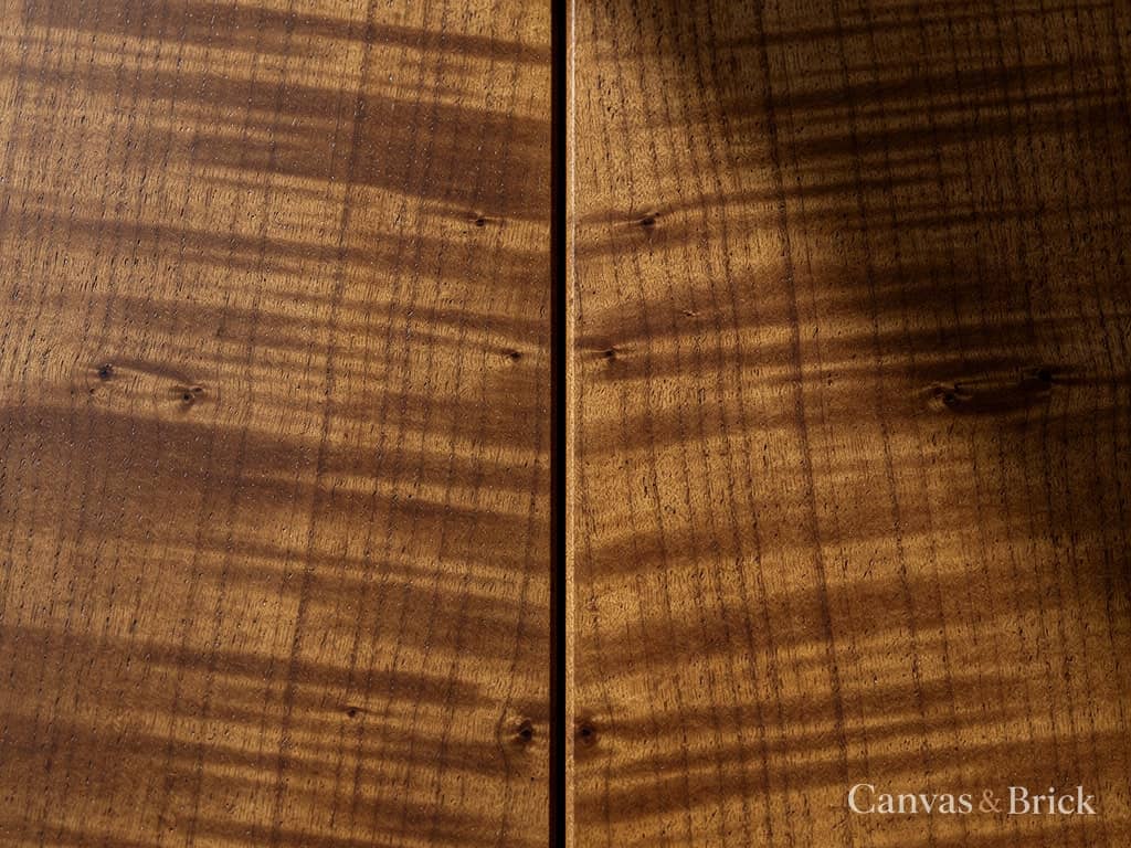 Book-matched natural walnut veneer panel with the grain mirrored along a central seam