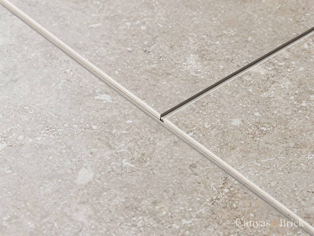 Large-format vitrified floor tile in a warm greige stone effect with a rectified edge